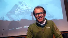 L'alpinista Simone Moro posa per i fotografi a Milano a margine della presentazione della collana di dvd "Le leggende dell'alpinismo. Storie di uomini e di montagne", 11 febbraio 2015. ANSA / MATTEO BAZZI