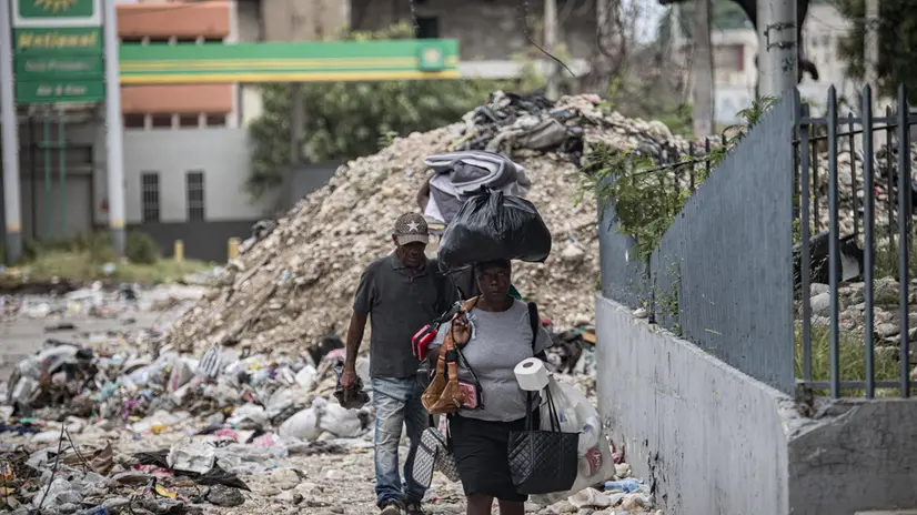 epa12197669 People walk along a street near the National Palace in Port-au-Prince, Haiti, 25 June 2025. Haiti marks one year since the first contingent of the Multinational Security Support (MSS) Mission arrived in the Caribbean country on 25 June 2024. UN High Commissioner for Human Rights Volker Turk has said the shortfalls in resources and equipment limited the MSS ability to contain the violence, with gangs extending their reach beyond Port-au-Prince and into the central regions, leaving a record 1.3 million people displaced and at least 2,680 people were killed between 01 January and 30 May 2025. EPA/MENTOR DAVID LORENS