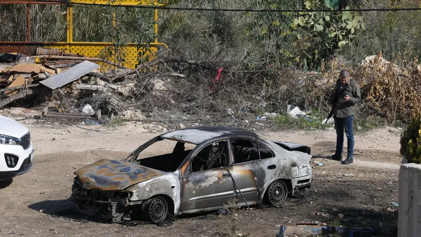 epa11756067 A damaged car in the village of Huwara, near the West Bank city of Nablus, 04 December 2024. According to the Palestinian news agency Wafa, Israeli settlers set a Palestinian house and two vehicles on fire in Hawara, south of Nablus. Israel's military said that a 'violent disturbance' took place in the Huwara area, in which Israeli civilians set fire to property and threw stones. According to Israel Police, eight suspects were arrested for assaulting security forces, scuffling, and causing damage to property in the Palestinian villages of Beit Furik and Huwara. EPA/ALAA BADARNEH