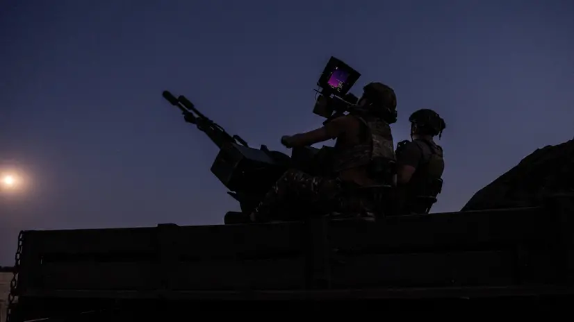 epa12227506 Two soldiers from a Ukrainian Army anti-aircraft artillery brigade scan their sector for Shahed drones on Ukraine's southern frontline on the night Russia launched the largest combined airstrike since it began its full-scale invasion of Ukraine, 08 July 2025. The unit operates a truck-mounted ZU-23-2 air defence system with a twin 23-calibre gun capable of targeting objects flying below 2,500 metres. EPA/Maria Senovilla