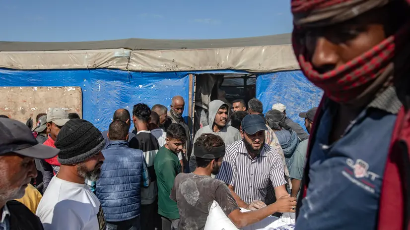 epa11693915 Palestinians receive bags of flour handed out by a United Nations Relief and Works Agency for Palestine Refugees in the Near East (UNRWA) aid distribution center in Khan Younis, southern Gaza Strip, 31 October 2024. According to the UN, at least 1.9 million people (or nine in ten people) across the Gaza Strip are internally displaced, including people who have been repeatedly displaced. Since October 2023, only about 11 percent of the Gaza Strip has not been placed under Israeli-issued evacuation orders, the UN aid coordination office OCHA said. EPA/HAITHAM IMAD