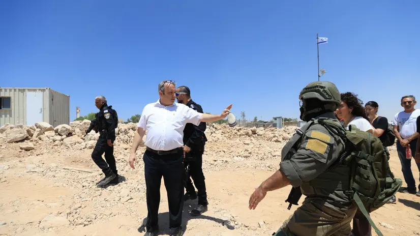 epa12275323 Israeli police stop Israeli Knesset member Gilad Kariv (C) as he attempts to reach settlers operating a bulldozer (unseen) in Khirbet Umm Al-Khair, Hebron governorate, West Bank, 31 July 2025. According to the Palestinian Ministry of Health, Palestinian teacher and human rights activist Odeh Al-Hathalin, 31, succumbed to his wounds after being shot on 28 July by an Israeli settler while reportedly trying to prevent the bulldozing of Palestinian lands in the village. EPA/ALAA BADARNEH