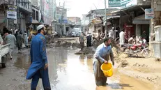 epa12304370 People survey damage caused by flash floods in Swat, Pakistan, 16 August 2025. Heavy rains and cloudbursts followed by flash-floods killed at least 194 people and injured 28 others in 24 hours in northern Pakistan as authorities were still struggling to provide relief goods to the affected regions, according to The National Disaster Management Authority (NDMA). EPA/HASEEB ALI