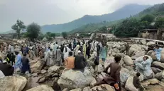 epa12306125 People survey a damaged area after flash floods in Buner, Khyber Pakhtunkhwa province, Pakistan, 17 August 2025. Heavy rains and cloudbursts followed by flash-floods in northern Pakistan killed at least 300 people, while at least 150 are still missing, as authorities were still struggling to provide relief goods to the affected regions, according to The National Disaster Management Authority (NDMA). EPA/NAVEED ALI