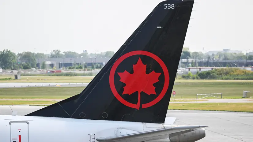 epa12300334 An Air Canada plane at a gate at Montreal-Trudeau International Airport, in Montreal, Quebec, Canada, 14 August 2025. Air Canada is facing a near-total shutdown, as the union plans to strike after talks with flight attendants broke down over pay and unpaid work. EPA/GRAHAM HUGHES