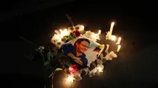 epa10805042 Supporters light candles around a photograph of the murdered Fernando Villavicencio, during a rally in Quito, Ecuador, 17 August 2023. Ecuador will hold its extraordinary presidential and legislative elections on 20 August, immersed in a deep and complex security crisis that had one of its most tragic episodes in the recent assassination of presidential candidate Fernando Villavicencio. EPA/Jose Jacome
