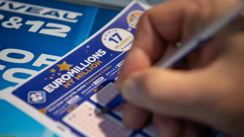 epa08862324 A person plays a EuroMillions grid in Bordeaux, France, 04 December 2020. The jackpot for this draw will reach 200 million euro. Before 2020, the jackpot was capped at 190 million euros. EPA/CAROLINE BLUMBERG