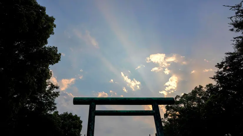 epa08602867 Rays of sunlight break through gaps in the cloudy sky over a Torii gate at the Yasukuni Shrine in Tokyo, Japan, 14 August 2020, the eve of the 75th anniversary of Imperial Japan surrendering in World War II. The Japanese government in 1963 said that Japanese casualties during the war were counted at about 3.1 million people killed. Yasukuni Shrine has been in the center of controversy since years and has never been visited by a Japanese Emperor since also Japanese Class A war criminals were laid to rest at the shrine. EPA/KIMIMASA MAYAMA