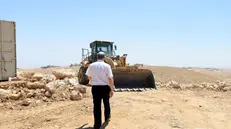 epa12275318 Israeli Knesset member Gilad Kariv approaches a settler operating a bulldozer in Khirbet Umm Al-Khair, Hebron governorate, West Bank, 31 July 2025. According to the Palestinian Ministry of Health, Palestinian teacher and human rights activist Odeh Al-Hathalin, 31, succumbed to his wounds after being shot on 28 July by an Israeli settler while reportedly trying to prevent the bulldozing of Palestinian lands in the village. EPA/ALAA BADARNEH