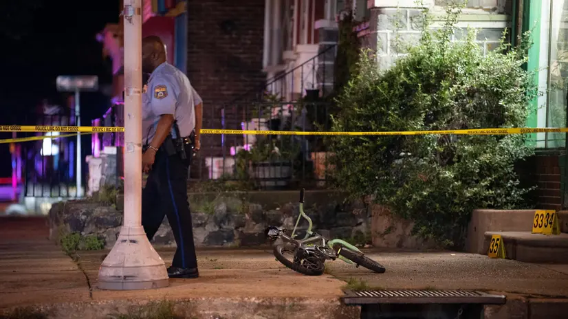 epa10725056 A bicycle belonging to one of the victims, a child who survived shots to the leg, lies at the scene of a mass shooting in the Kingsessing section of South Philadelphia, Pennsylvania, USA, 03 July 2023. Four people were killed and two others injured by a suspect who police placed into custody after capturing him wearing a bulletproof vest and carrying multiple weapons, according to the Philadelphia Police Department. EPA/TRACIE VAN AUKEN