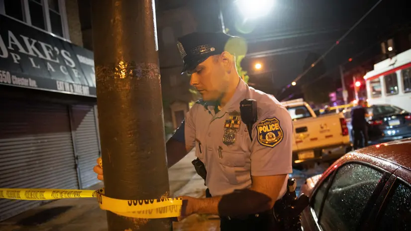 epa10725050 Police officials work at the scene of a mass shooting in the Kingsessing section of South Philadelphia, Pennsylvania, USA, 03 July 2023. Four people were killed and two others injured by a suspect who police placed into custody after capturing him wearing a bulletproof vest and carrying multiple weapons, according to the Philadelphia Police Department. EPA/TRACIE VAN AUKEN