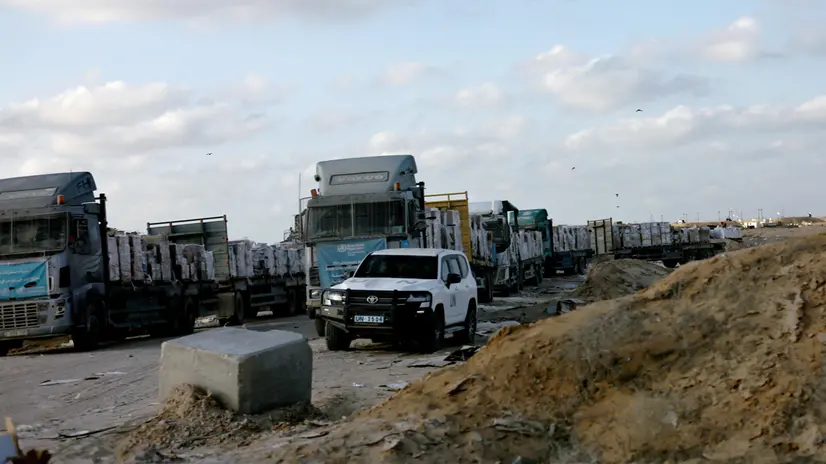 epa12275526 A photo taken while embedded with the Israeli Army shows Palestinian trucks carrying humanitarian aid on the Palestinian side of the Kerem Shalom border crossing, between the Gaza Strip and Israel, 31 July 2025. EPA/ATEF SAFADI