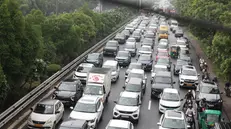 epa12274308 Hundreds of cars are stuck in a traffic jam on the expressway leading to Delhi near New Delhi, India, 31 July 2025. Traffic movement was affected in many parts of the Indian capital's key routes due to heavy rainfall since early morning. EPA/HARISH TYAGI