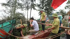 epa12320705 A handout photo made available by Vietnam News Agency shows people working to bring boats ashore to ensure safety as Typhoon Kajiki nears in Thanh Hoa, Vietnam, 24 August 2025 (issued 25 August 2025). Authorities in Vietnam are evacuating more than 500,000 people from central coastal provinces where Typhoon Kajiki is forecast to make landfall. EPA/VIETNAM NEWS AGENCY / HANDOUT VIETNAM OUTHANDOUT EDITORIAL USE ONLY/NO SALES