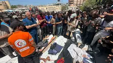 epa12321406 People pray in front of the bodies of Palestinians killed in an Israeli airstrike at Nasser Hospital in Khan Younis, southern Gaza Strip, 25 August 2025. According to the Palestinian Health Ministry, the airstrike hit the fourth floor of the Nasser Medical Complex, followed by a second attack upon the arrival of ambulance crews to retrieve the injured and the dead, leaving at least 20 killed, including 5 journalists. EPA/HAITHAM IMAD