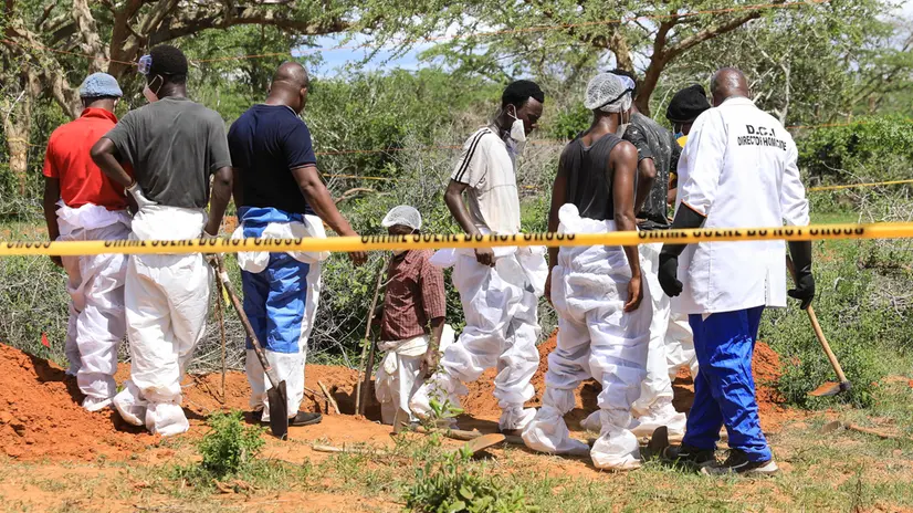 epa10588058 Kenyan homicide detectives and forensic experts from the Directorate of Criminal Investigations (DCI), examine exhumed bodies from several shallow mass graves of suspected members of a Christian cult after starving themselves to death, after allegedly being told by their controversial preacher Paul Mackenzie that they would go to heaven if they starved themselves to death, in the coastal Shakahola forest, in Kilifi, Kenya, 23 April 2023. According to the Police, 18 more bodies were exhumed on 23 April bringing the tally of bodies recovered to at 39. EPA/STR