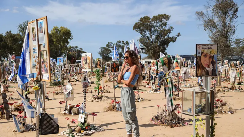 epa11641457 A woman looks at pictures and memorials for Israeli festival goers who killed by Hamas at the site of the Supernova Music Festival rave near Kibbutz Reim, Southern Israel, 19 September 2024. On 7 October 2023, the Palestinian group Hamas launched a coordinated attack from Gaza into Israel, with thousands of rockets fired and with militants’ staging land incursions into kibbutz communities and cities. The participants of the Nova music festival were also among other targets in the area of southern Israel bordering Gaza. The unprecedented attack was followed by an air and land offensive of the Israeli Army in the Gaza Strip, with massive displacement of its population and tens of thousands killed in almost one year of conflict. According to Israeli official sources, 1,139 people were killed in the Hamas attack including 695 Israeli civilians and 71 foreigners as well as 373 members of the security forces. Hamas militants also took 251 hostages, 117 of which have been released alive with 37 dead. The rest remain in captivity. After one year of war, the death toll reached 1,638 in Israel, among them 860 civilians, according to the National Insurance Office. EPA/ABIR SULTAN ATTENTION: This Image is part of a PHOTO SET