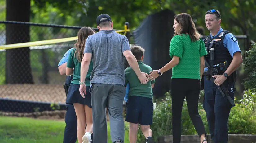 epa12327018 People leave the school as police respond to a shooting at the Annunciation Catholic School in Minneapolis, Minnesota, USA, 27 August 2025. According to police, three people including the gunman died in the shooting at a Catholic primary church and 20 were injured. EPA/CRAIG LASSIG