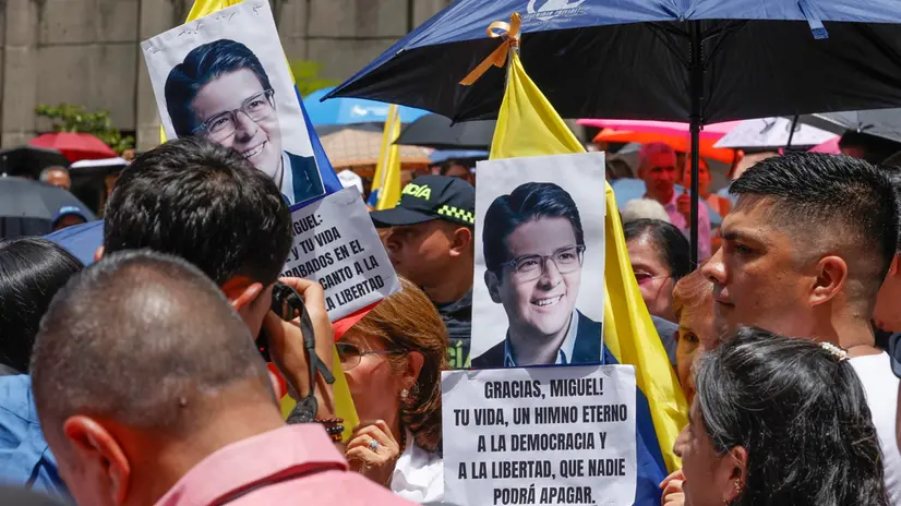 epa12296379 People hold pictures of the late Colombian senator and presidential candidate Miguel Uribe Turbay during a tribute in Medellin, Colombia, 12 August 2025. Colombia's major capital cities held posthumous tributes to Uribe Turbay, who died on 11 August, two months after being seriously injured in an attack in Bogota. EPA/Mauricio Duenas Castaneda