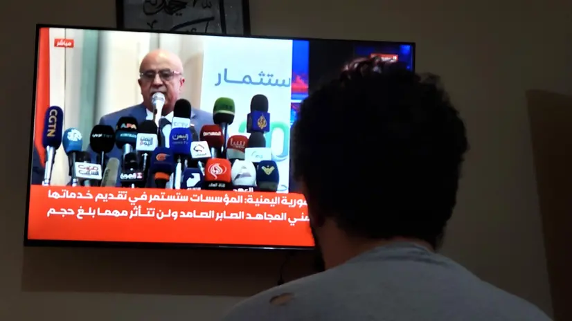 epa12336961 A man watches a TV showing Houthi Prime Minister Ahmed Al-Rahawi, in Sana'a, Yemen, 30 August 2025. Ahmed Al-Rahawi was killed following Israeli airstrikes in the capital on 28 August, Yemen's Houthis confirmed. EPA/YAHYA ARHAB