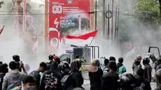 epa12336079 Protesters clash with police outside the parliament building in Denpasar, Bali, Indonesia, 30 August 2025. Civilians, including motorcycle taxi drivers, protested in Bali after the death of a driver who was allegedly run over by a police vehicle during demonstrations on the night of 28 August in Jakarta. EPA/MADE NAGI
