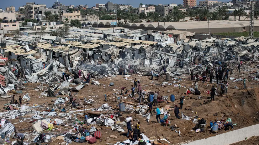 epa12314038 Displaced Palestinians inspect tents destroyed after an Israeli strike on the Al-Manasrah camp, which housed more than 200 families in Deir al-Balah, central Gaza Strip, 21 August, 2025. EPA/HAITHAM IMAD