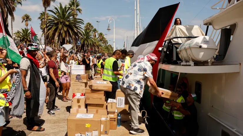epa12339958 Volunteers load aid packages onto the ships of Flotilla Global Sumud before the departure at the port in Barcelona, northeastern Spain, 31 August 2025. The Flotilla Global Sumud will depart from Barcelona to Gaza on 31 August in a humanitarian action in support of the Palestinian people. EPA/TONI ALBIR