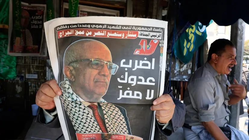 epa12339219 A person reads a local newspaper publishing news and portrait of Houthi government's Prime Minister Ahmed Al-Rahawi, after the Houthis announced his death in recent Israeli strikes, in Sana'a, Yemen, 31 August 2025. Ahmed Al-Rahawi and several other senior Houthi officials were killed in Israeli strikes in the capital Sana'a on 28 August 2025, according to Yemen's Houthis. EPA/YAHYA ARHAB
