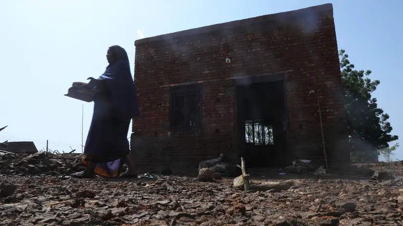epa10135158 A Sudanese woman collects damaged belongings due to floods at Al Manaqil area of Al Jazirah state, Sudan, 23 August 2022. According to the Sudanese Council for Civil Defense, at least 79 people died in incidents related to the recent floods in the country. Thousands of homes were damaged due to the floods that affected South Darfur, North Kordofan, and Al Jazirah state. EPA/MOHND AWAD