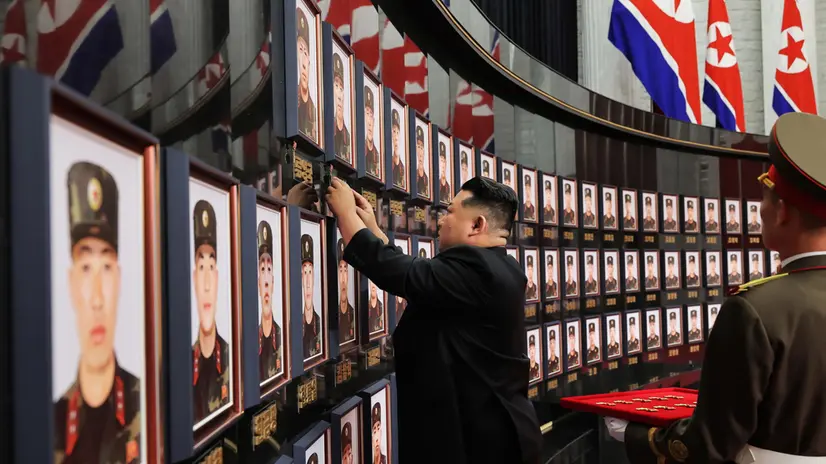 epa12315835 An undated photo released by the official Korean Central News Agency (KCNA) shows North Korean leader Kim Jong Un (C) fixing the 'DPRK Hero Medal' beside the portraits of martyrs during a ceremony honoring Korean People’s Army (KPA) soldiers who took part in unspecified overseas operations at the headquarters of the Workers’ Party of Korea in Pyongyang, North Korea (issued 22 August 2025). According to KCNA, Kim conferred state commendations, including the title of DPRK Hero, to military commanders and martyrs, and met with bereaved families to offer condolences. EPA/KCNA EDITORIAL USE ONLY