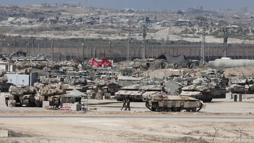 epa12345927 Israeli soldiers with military vehicles gather at a position near the border fence with the Gaza Strip, as seen from the Israeli side of the border, in southern Israel, 02 September 2025. Israel's military said it is stepping up logistical and operational preparations ahead of expanded combat operations and a large-scale mobilization of reservists. EPA/ABIR SULTAN