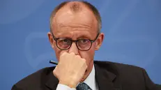 epa12349936 German Chancellor Friedrich Merz looks on during a press conference following a meeting of the coalition committee at the chancellery in Berlin, Germany, 03 September 2025. EPA/CLEMENS BILAN