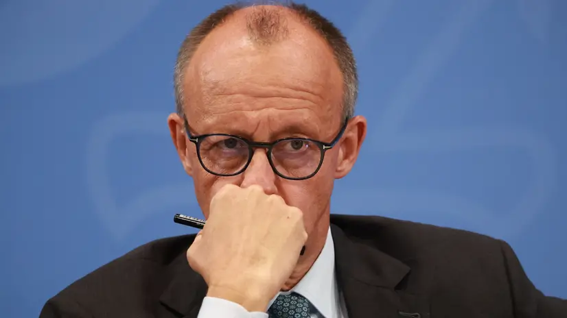 epa12349936 German Chancellor Friedrich Merz looks on during a press conference following a meeting of the coalition committee at the chancellery in Berlin, Germany, 03 September 2025. EPA/CLEMENS BILAN
