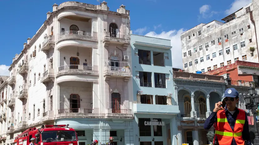 epa10465630 Cuban firefighters and police inspect the area near the Caribe Hotel after a blast in Havana, Cuba, 13 February 2023. At least a person was injured after the blast, allegedly due to a gas leak, according an official source. EPA/Yander Zamora