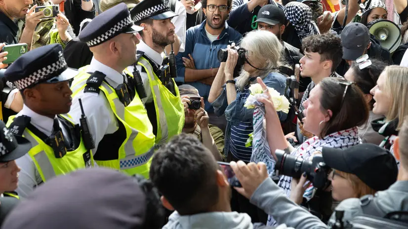 epa12357207 Police stand guard as supporters of the banned Palestine Action group stage a civil disobedience protest in Parliament Square in London, Britain, 06 September 2025. The Metropolitan Police made arrests during the demonstration supporting Palestine Action, designated a proscribed terrorist organization by the British government from 05 July 2025. EPA/TAYFUN SALCI