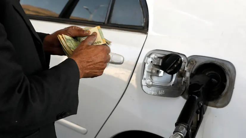 epa09824658 An attendant counts money as he pumps fuel into a vehicle at a gasoline station amid an acute fuel shortage in Sana'a, Yemen, 14 March 2022. Yemen is experiencing its worst fuel crisis since the start of the seven-year-long conflict due to Saudi Arabia and UAE-imposed stringent restrictions on fuel imports to the war-ravaged Arab country as well as the oil price spike globally because of the Russian invasion of Ukraine. The Yemen petroleum company warned that the severe fuel shortage is likely to get worse in the coming days. EPA/YAHYA ARHAB