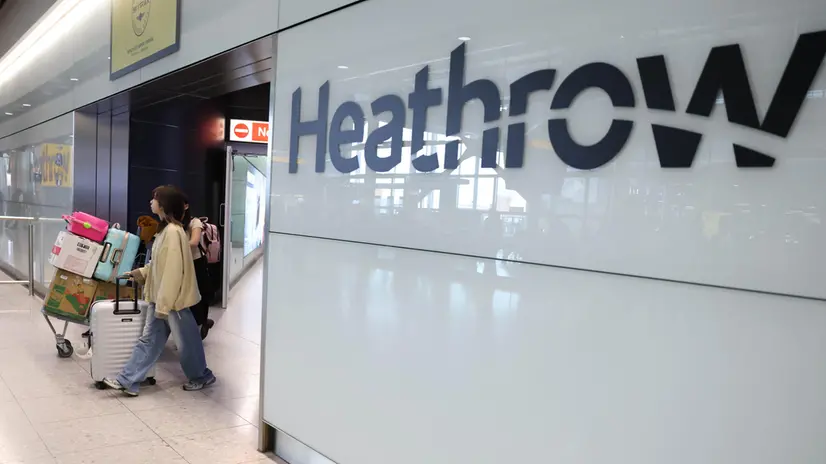epa11980829 Passengers walk with their luggage at Terminal 2 arrivals at Heathrow Airport in Hounslow, Britain, 22 March 2025. Flights resumed at Heathrow Airport following a power outage on 21 March 2025. A fire at a substation which supplies power to Heathrow forced its closure for most of 21 March, leading to thousands of cancelled flights and stranding passengers across the world. Heathrow is Europe's busiest Airport and the Metropolitan Police’s Counter Terrorism Command is leading the investigation into the cause of the fire at the electrical substation. EPA/NEIL HALL