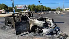 epa10391493 A burnt-out vehicle after clashes between federal forces and armed groups following the capture of Ovidio Guzman, an alleged drug trafficker and the son of 'Chapo' Guzman, in the city of Culiacan, state of Sinaloa, Mexico, 05 January 2023. In the midst of strong security Guzman was transferred to the same prison where his father had previously escaped. As part of a security strategy and in order to not make the information public, the Mexican authorities first sent a convoy of eight vehicles that left around 5:30 p.m. (23:30 GMT) from the Specialized Prosecutor for Organized Crime (Femdo) building in Mexico City and after 6:00 p.m. (00:15 GMT) a helicopter departed from the same place. EPA/Juan Carlos Cruz