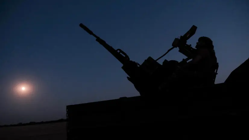 epa12227141 Two soldiers from a Ukrainian Army anti-aircraft artillery brigade scan their sector for Shahed drones on Ukraine's southern frontline on the night Russia launched the largest combined airstrike since it began its full-scale invasion of Ukraine, 08 July 2025. The unit operates a truck-mounted ZU-23-2 air defence system with a twin 23-calibre gun capable of targeting objects flying below 2,500 metres. EPA/Maria Senovilla