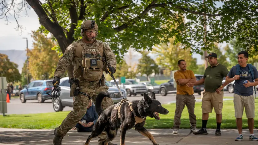epa12368534 A police officer walks with a K9 Unit following the shooting of Charlie Kirk, the CEO and co-founder of the conservative youth organization Turning Point USA, at Utah Valley University in Orem, Utah, USA, 10 September 2025. Kirk was shot at an event he was hosting at Utah Valley University and was removed from the premises by his security team, he later died in the hospital. A suspect is in custody. EPA/MARIELLE SCOTT