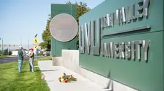 epa12369976 Flowers lay outside the Utah Valley University the day after Charlie Kirk, CEO and co-founder of the conservative youth organization Turning Point USA, was shot dead, at Utah Valley University in Orem, Utah, USA, 11 September 2025. Kirk was shot dead on 10 September at an event he was hosting at Utah Valley University. The suspect was still at large. EPA/MARIELLE SCOTT