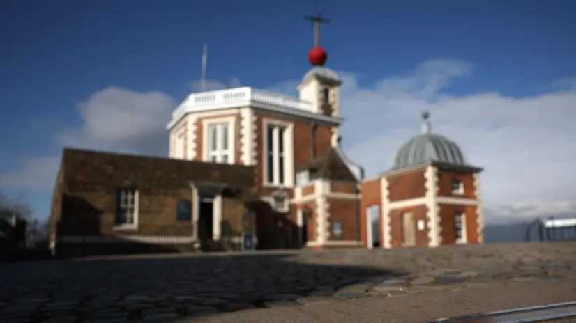 epa12002684 The Prime Meridian is marked out on the ground at Royal Observatory Greenwich in London, Britain, 12 March 2025 (issued 01 April 2025). The meridian line in Greenwich represents the Prime Meridian of the world, Longitude Zero (0Â° 0' 0"). Every place on the Earth is measured in terms of its angle east or west from this line. Since 1884, the Prime Meridian has also served as the reference point for Greenwich Mean Time (GMT) which was distributed both nationally, via the Time Ball installed in 1833, and the national standardization for Railway Time in 1852. The year 2025 marks 350 years since the foundation of the Royal Observatory, the first state-funded, purpose-built scientific institution in Britain. It was founded in 1675 by British King Charles II to make astronomical observations that could help navigators at sea determine their longitude (east-west position). EPA/NEIL HALL