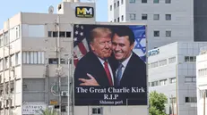 epa12370776 A billboard shows an image of US President Donald Trump (L) embracing US conservative political activist Charlie Kirk to honor Kirk following his fatal shooting, in Tel Aviv, Israel, 12 September 2025. Kirk, 31, was shot dead while speaking at Utah Valley University on 10 September 2025. EPA/ABIR SULTAN EPA