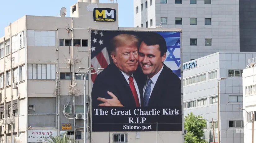 epa12370776 A billboard shows an image of US President Donald Trump (L) embracing US conservative political activist Charlie Kirk to honor Kirk following his fatal shooting, in Tel Aviv, Israel, 12 September 2025. Kirk, 31, was shot dead while speaking at Utah Valley University on 10 September 2025. EPA/ABIR SULTAN EPA