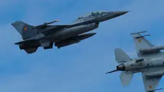 epa10973339 Two Romanian military jet pilots fly their F16 Falcons during a demonstration following the opening ceremony for the European F-16 Training Center, held at the 86th Air Base 'Lieutenant Aviator Gheorghe Mociornita', in Borcea, 156 kilometers south-east from Bucharest, Romania, 13 November 2023. The ETFC it is the first European dedicated training facility outside the United States territory that had all the means for training F16 pilots in order to facilitate the interoperability between NATO member countries. According to the project contract, Romanian Defense Ministry put the 86th Air Base at the training hub's disposal, including the tech training facilities and logistic support. The Netherlands already gave four pieces of F16 jet fighters for the training flights, and US company Lockheed Martin comes with the instructors and maintenance. At the EFTC are supposed to get the training the Ukrainian pilots that will handle the F16 that Ukraine will receive from its western allies, according to the NATO decision. EPA/Robert Ghement