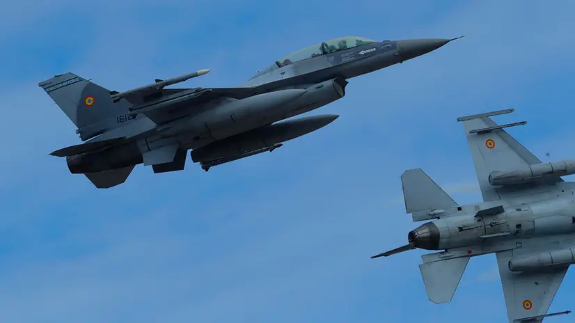 epa10973339 Two Romanian military jet pilots fly their F16 Falcons during a demonstration following the opening ceremony for the European F-16 Training Center, held at the 86th Air Base 'Lieutenant Aviator Gheorghe Mociornita', in Borcea, 156 kilometers south-east from Bucharest, Romania, 13 November 2023. The ETFC it is the first European dedicated training facility outside the United States territory that had all the means for training F16 pilots in order to facilitate the interoperability between NATO member countries. According to the project contract, Romanian Defense Ministry put the 86th Air Base at the training hub's disposal, including the tech training facilities and logistic support. The Netherlands already gave four pieces of F16 jet fighters for the training flights, and US company Lockheed Martin comes with the instructors and maintenance. At the EFTC are supposed to get the training the Ukrainian pilots that will handle the F16 that Ukraine will receive from its western allies, according to the NATO decision. EPA/Robert Ghement