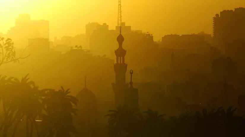 epa000284059 Mosque minarets in Islamic Cairo dot the skyline as the sun sets over the Middle East's largest city on Monday 27 September 2004. Cairo, a metropolis of 16 million people, is also called the City of a Thousand Mosques. EPA/MIKE NELSON