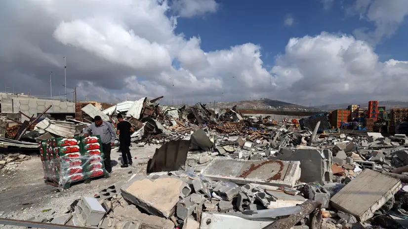epa12361686 Palestinians inspect the damage to their shops in the central vegetable market in Beita, south of Nablus in the West Bank, 08 September 2025. According to the Palestinian news agency Wafa, Israeli forces demolished shops in the market on Monday morning. EPA/ALAA BADARNEH