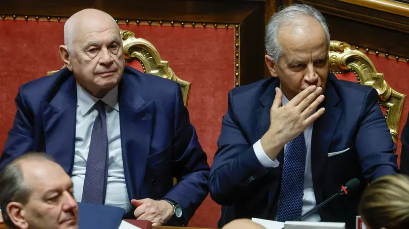Italy's Justice Minister Carlo Nordio (L) and Interior Minister Matteo Piantedosi react during a government briefing over the case of Libyan General Osama Najim Almasri, at the Senate, Rome, Italy, 05 February 2025. On 21 January the Italian government released and repatriated Almasri after a brief detention over an International Criminal Court (ICC) arrest warrant. The general is wanted by the ICC over allegations of war crimes and crimes against humanity. ANSA/FABIO FRUSTACI