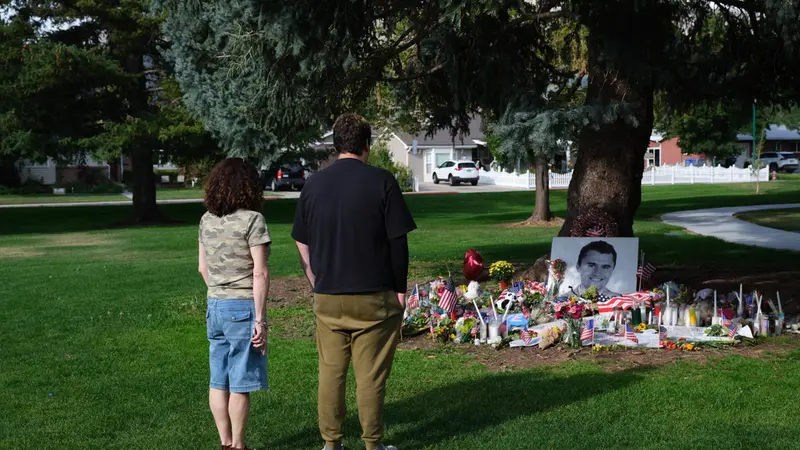 epaselect epa12373918 People look at tributes to slain conservative political activist Charlie Kirk, in Provo, Utah, USA, 12 September 2025 (issued 13 September 2025). Kirk was shot and killed on 10 September during a stop on his American Comeback Tour organized by Turning Point USA at Utah Valley University. Tyler Robinson has been arrested and identified as the suspected shooter. EPA/LINDSAY D'ADDATO